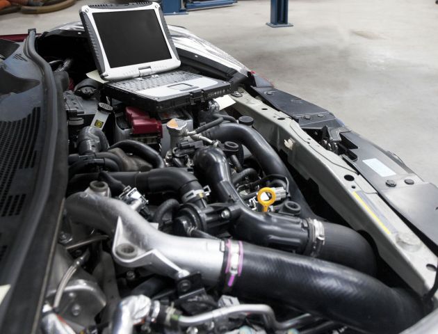 Ai Remap, expert car tuning Birmingham – car-in-a-workshop-and-a-computer-running-diagnosti-2025-04-03-20-32-22-utc-1-scaled